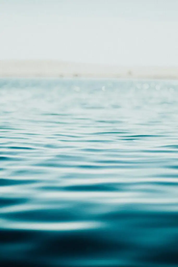Serene ocean surface captured in soft focus, evoking calm and tranquility.